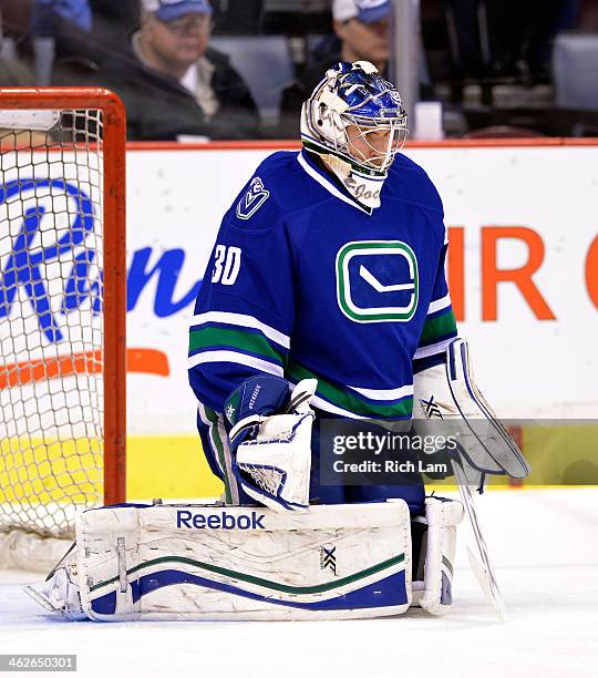 Goalie Joacim Eriksson of the Vancouver Canucks makes a save during the pre-game warmup prior to NHL action against the Tampa Bay Lightning on...