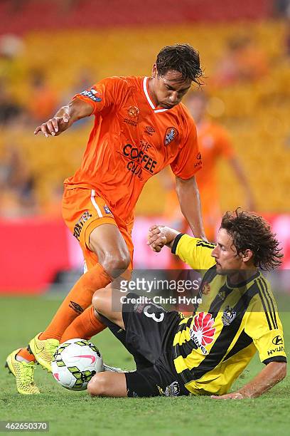 Adam Sorota of the Roar and Albert Riera of the Phoenix compete for the ball during the round 16 A-League match between the Brisbane Roar and the...