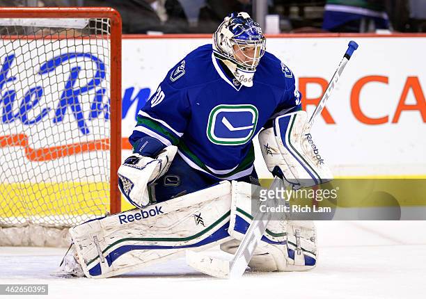 Goalie Joacim Eriksson of the Vancouver Canucks makes a save during the pre-game warmup prior to NHL action against the Tampa Bay Lightning on...