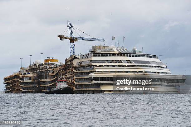 View of the Costa Concordia the day after the commemoration for its sinking on January 14, 2014 in Giglio Porto, Italy. Two years after the sinking...