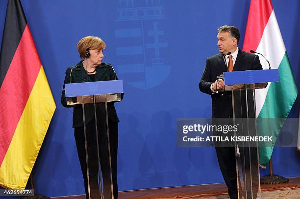 German Chancellor Angela Merkel chats with her host Hungarian Prime Minister Viktor Orban in the parliament building of Budapest on February 2, 2015...