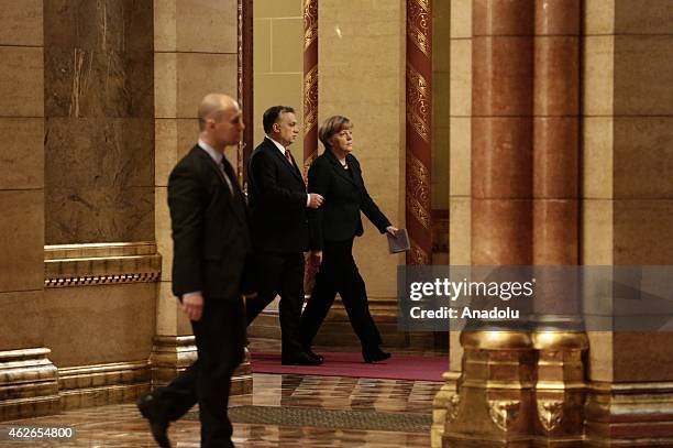 Hungary's prime minister Viktor Orban and German Chancellor Angela Merkel walks together to hold a meeting during Merkel's official visit in front of...