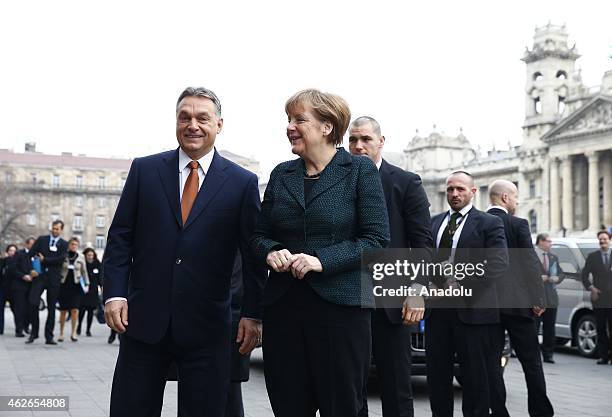 Hungary's prime minister Viktor Orban welcomes German Chancellor Angela Merkel during Merkel's official visit in front of the Parliament building in...