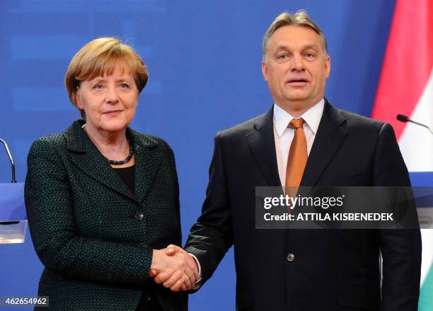German Chancellor Angela Merkel is welcomed by Hungarian Prime Minister Viktor Orban in the parliament in Budapest on February 2, 2015 during...