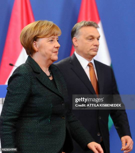 German Chancellor Angela Merkel and Hungarian Prime Minister Viktor Orban leave after a meeting in the parliament in Budapest on February 2, 2015...