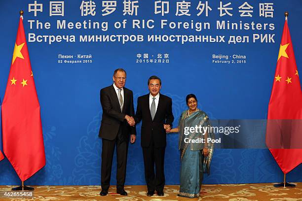 Russian Foreign Minister Sergei Lavrov , Chinese Foreign Minister Wang Yi and Indian Foreign Minister Sushma Swaraj shake hands before the 13th...