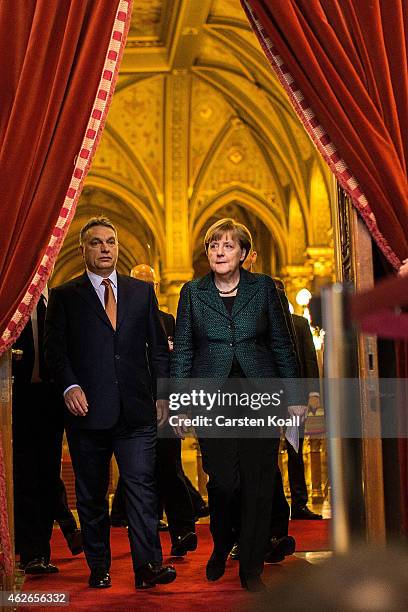 German Chancellor Angela Merkel and Hungarian Prime Minister Viktor Orban arrive for a press conference following talks on February 2, 2015 in...