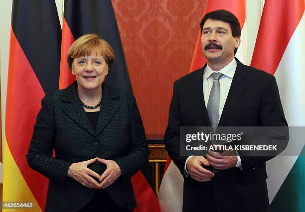 German Chancellor Angela Merkel is welcomed by Hungarian President Janos Ader in Maria Theresia hall of the presidental palace in Budapest on...