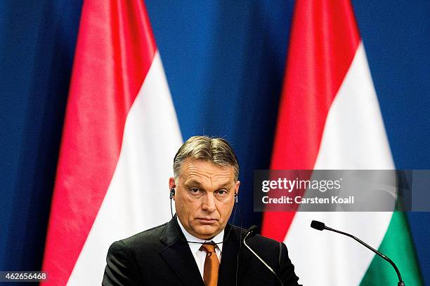 Hungarian Prime Minister Viktor Orban listens during a press conference with German Chancellor Angela Merkel following talks on February 2, 2015 in...