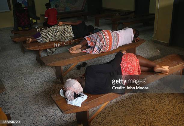 People await medical treatment in the outpatient lounge of Redemption Hospital, formerly an Ebola holding center, on February 2, 2015 in Monrovia,...