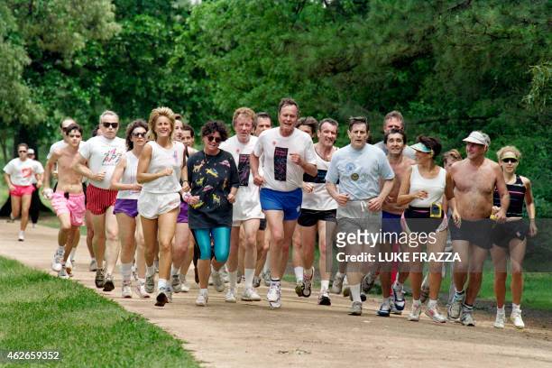 President George Bush attracts a small crowd as he jogs on April 6, 1991 in a Houston park near his residence. Bush will meet with Mexican President...