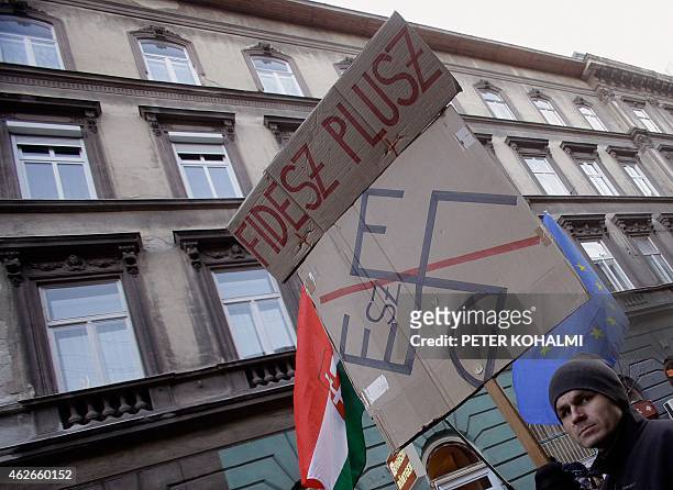 Protester holds an anti-government banner close to Andrassy university in Budapest on February 2, 2015 during their demonstration to protest against...