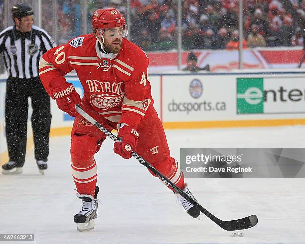 Henrik Zetterberg of the Detroit Red Wings skates up ice with the puck against the Toronto Maple Leafs during the Bridgestone NHL Winter Classic on...