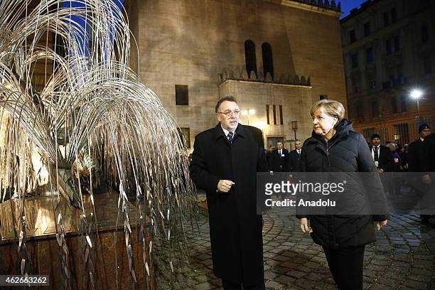 German Chancellor Angela Merkel is informed about a statue by the president of the Federation of the Jewish Communities in Hungary Andras Heisler at...
