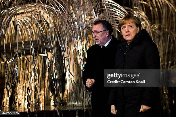 Andras Heisler , President of Federation of Jewish Communities in Hungary, shows German Chancellor Angela Merkel the "Tree of Life" in the Dohany...