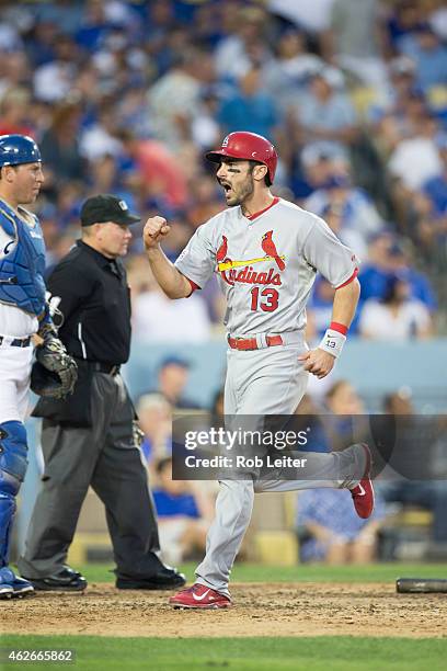 Matt Carpenter of the St. Louis Cardinals reacts to scoring on a Matt Holliday three-run home run in the seventh inning of Game 1 of the NLDS against...