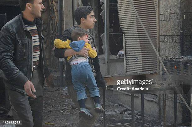 An injured Syrian kid is taken to hospital after Syrian regime's air forces' air attack on East Ghouta region with 'Vacuum Bomb' that killed at least...