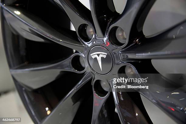 The Tesla Motors Inc. Logo is seen on the hubcap of a Model S sedan at the company's booth during the 2014 North American International Auto Show in...