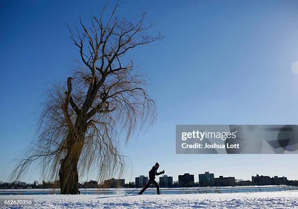 Man cross country skis along the Detroit River on Belle Isle February 2, 2015 in Detroit, Michigan. Detroit received over a foot of snow during a...
