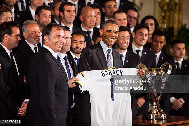 February 2: President Barack Obama holds a commemorative jersey with his name and the number 1 given to him by Galaxy head coach Bruce Arena after he...