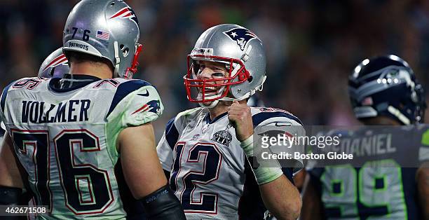 Patriots quarterback Tom Brady celebrates on the field with offensive lineman Sebastian Vollmer, left, just before he took a final knee to end the...