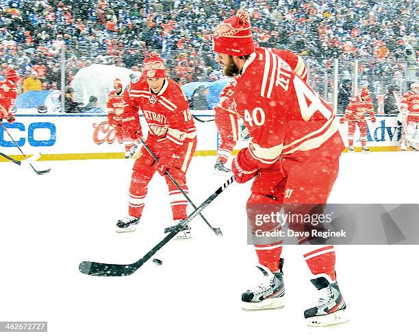 Henrik Zetterberg and Pavel Datsyuk of the Detroit Red Wings pass the puck to each other in warm-ups before the Bridgestone NHL Winter Classic game...