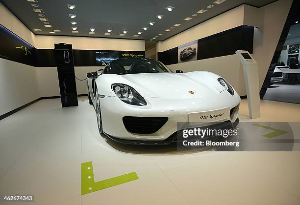 Porsche AG 918 Spyder E-hybrid vehicle is displayed during the 2014 North American International Auto Show in Detroit, Michigan, U.S., on Tuesday,...