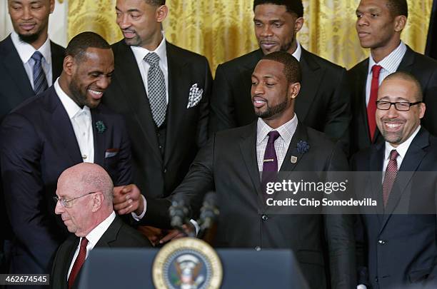 National Basketball Association 2012-2013 champion Miami Heat player Dwyane Wade rubs the back of Assistant Coach Ron Rothstein's head before the...