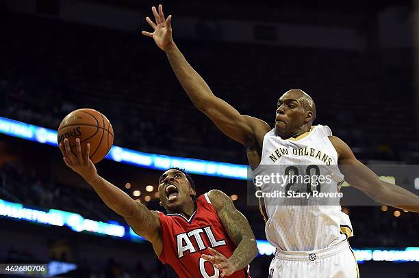 Jeff Teague of the Atlanta Hawks drives to the basket against Quincy Pondexter of the New Orleans Pelicans during the first half of a game at the...