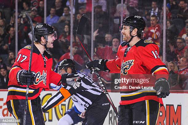 Lance Bouma of the Calgary Flames congratulates teammate David Jones on his goal against the Winnipeg Jets in the first period during an NHL game at...