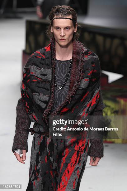 Model walks the runway during the Roberto Cavalli show as a part of Milan Fashion Week Menswear Autumn/Winter 2014 on January 14, 2014 in Milan,...