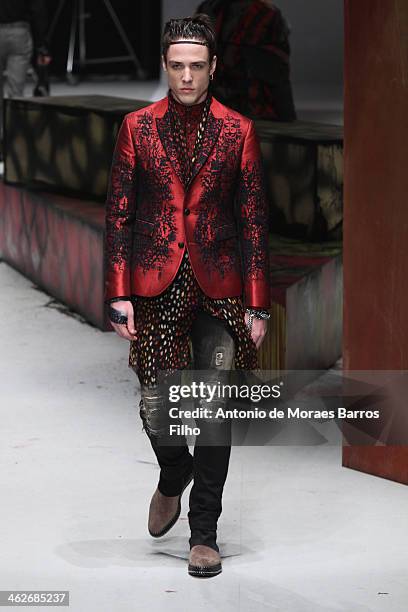 Model walks the runway during the Roberto Cavalli show as a part of Milan Fashion Week Menswear Autumn/Winter 2014 on January 14, 2014 in Milan,...