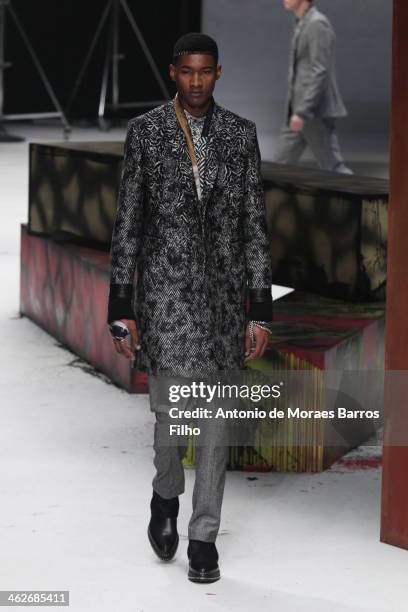 Model walks the runway during the Roberto Cavalli show as a part of Milan Fashion Week Menswear Autumn/Winter 2014 on January 14, 2014 in Milan,...