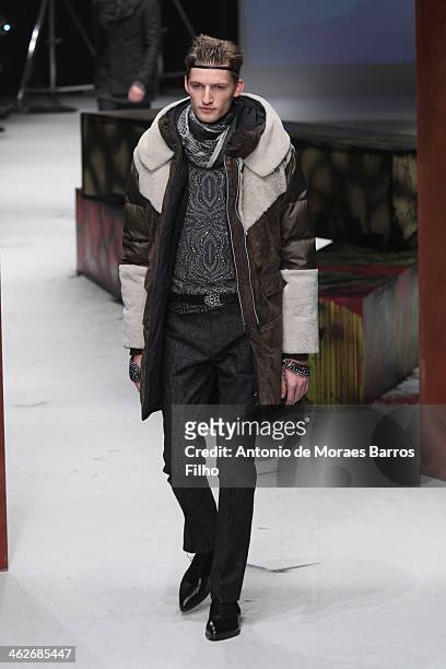 Model walks the runway during the Roberto Cavalli show as a part of Milan Fashion Week Menswear Autumn/Winter 2014 on January 14, 2014 in Milan,...