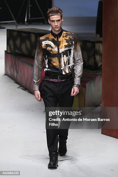 Model walks the runway during the Roberto Cavalli show as a part of Milan Fashion Week Menswear Autumn/Winter 2014 on January 14, 2014 in Milan,...