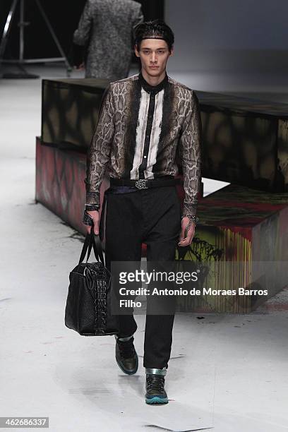 Model walks the runway during the Roberto Cavalli show as a part of Milan Fashion Week Menswear Autumn/Winter 2014 on January 14, 2014 in Milan,...
