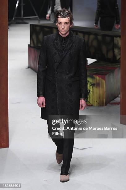 Model walks the runway during the Roberto Cavalli show as a part of Milan Fashion Week Menswear Autumn/Winter 2014 on January 14, 2014 in Milan,...