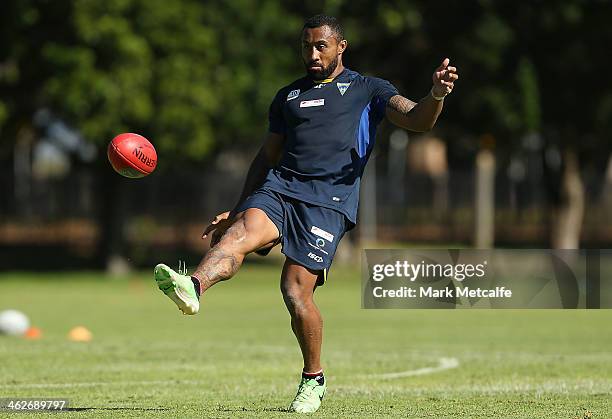 Roy Asotasi of the Warrington Wolves kicks an AFL ball during a Sydney Swans AFL pre-season training session at Lakeside Oval on January 15, 2014 in...