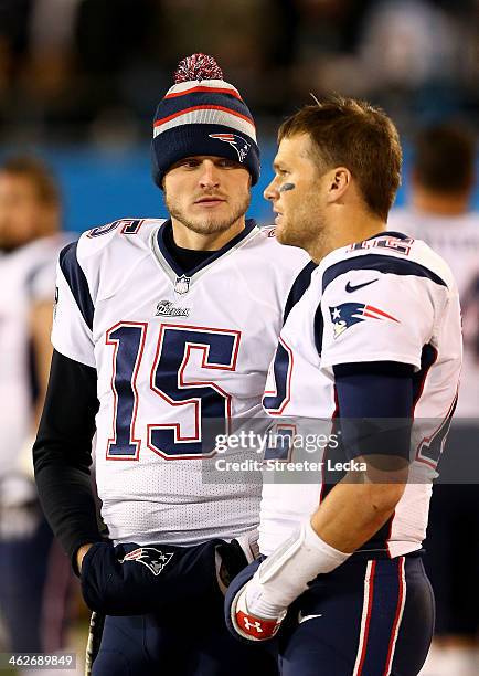 Teammates Ryan Mallett and Tom Brady of the New England Patriots during their game at Bank of America Stadium on November 18, 2013 in Charlotte,...