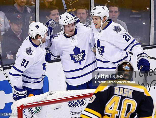 Tyler Bozak of the Toronto Maple Leafs is congratulated by teammates Phil Kessel and James van Riemsdyk following his second goal in the first period...
