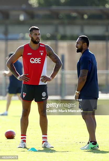 Lance Franklin of the Swans talks to Roy Asotasi of the Warrington Wolves during a Sydney Swans AFL pre-season training session at Lakeside Oval on...