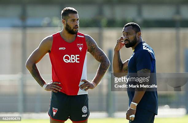 Lance Franklin of the Swans talks to Roy Asotasi of the Warrington Wolves during a Sydney Swans AFL pre-season training session at Lakeside Oval on...
