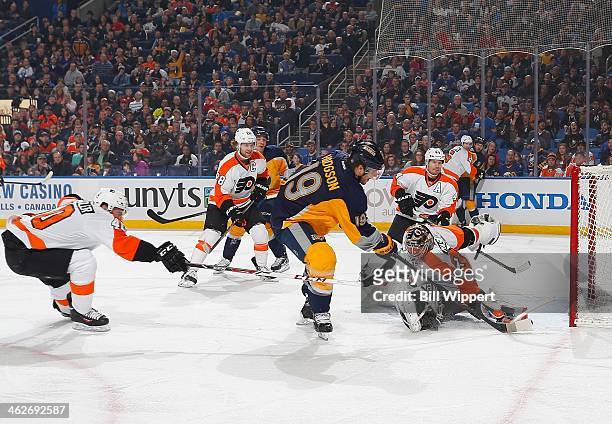 Cody Hodgson of the Buffalo Sabres scores a first period goal just out of reach of Steve Mason and Vincent Lecavalier of the Philadelphia Flyers on...