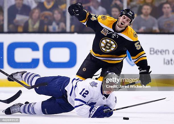 Adam McQuaid of the Boston Bruins is called for a tripping penalty on Mason Raymond of the Toronto Maple Leafs in the second period during the game...