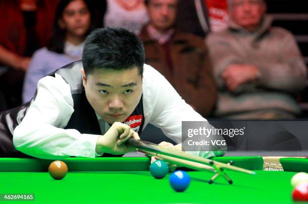 Ding Junhui of China plays a shot against Shaun Murphy of England on day three of the 2014 Dafabet Masters at the Alexandra Palace on January 14,...