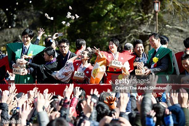 Actors throw beans while people try to catch them during a bean scattering ceremony to mark the end of winter at Naritasan Shinshoji Temple on...