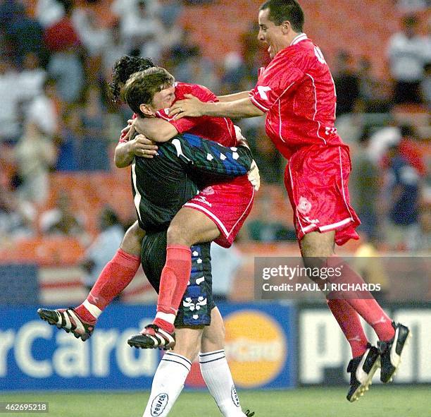 Toluca F.C. Goalie Herman Cristante is congratulated by teammates after deflecting shoot-out kicks for Toluca's 2-1 win over Deportivo Saprissa...