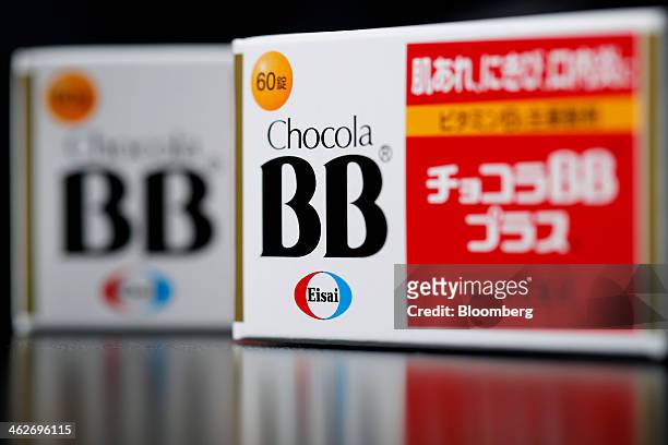 Eisai Co.'s Chocola BB Plus vitamin B2 preparation packets are arranged for a photograph in Tokyo, Japan, on Tuesday, Jan. 14, 2014. Eisai is...