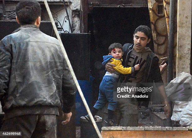 Injured Syrians are taken to hospitals after Syrian regime's air forces' air attack on East Ghouta region with 'Vacuum Bomb' that killed at least 10...