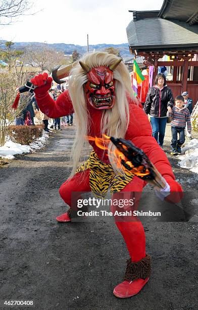 Man wearing ogre costume holding a flaming torch performs the Oni-Horaku, or ogre dance Henshoji Temple on February 3, 2015 in Showa, Gunma, Japan....